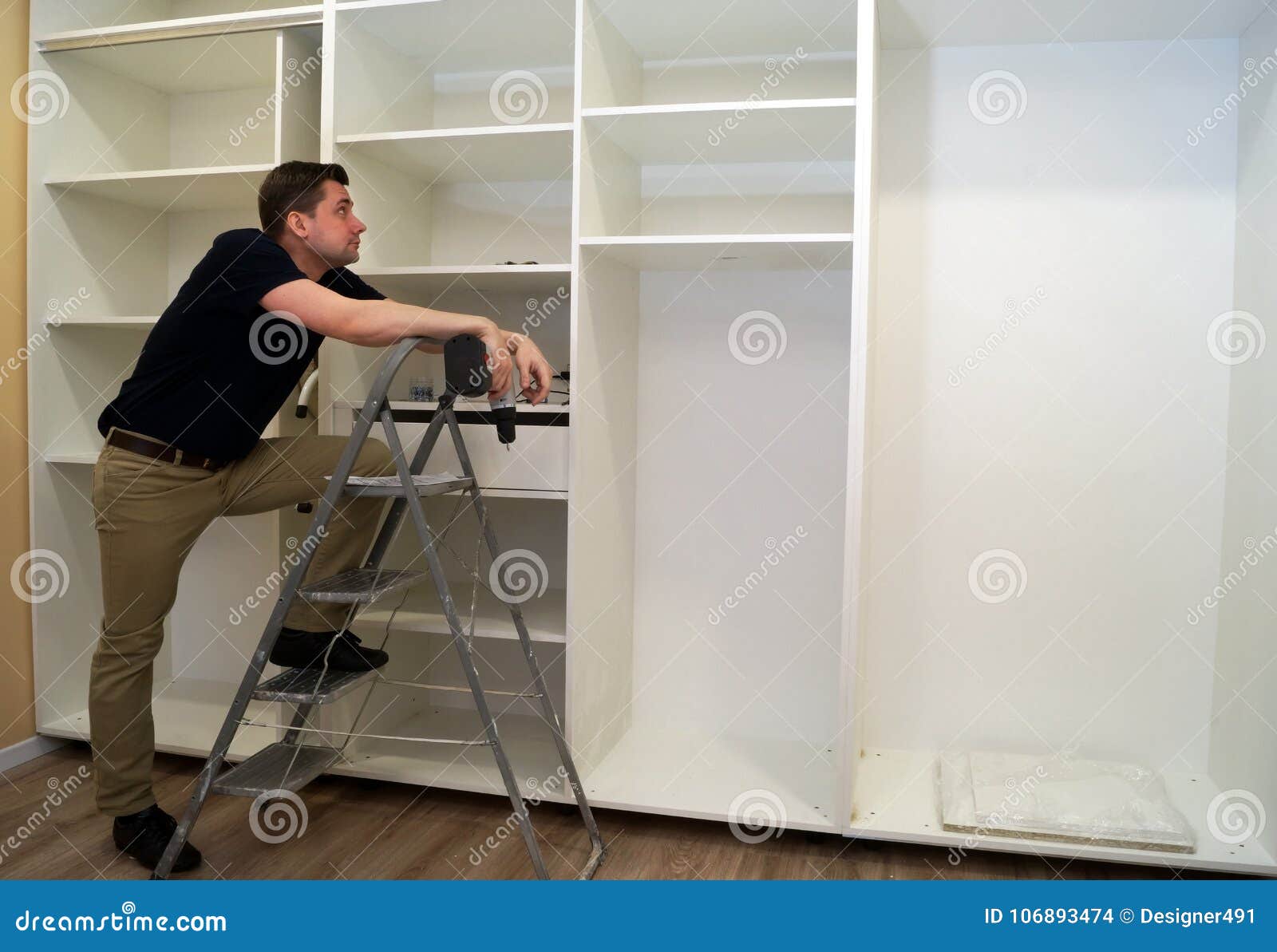 Worker Looking at Wardrobe. Assembly Concept Stock Photo