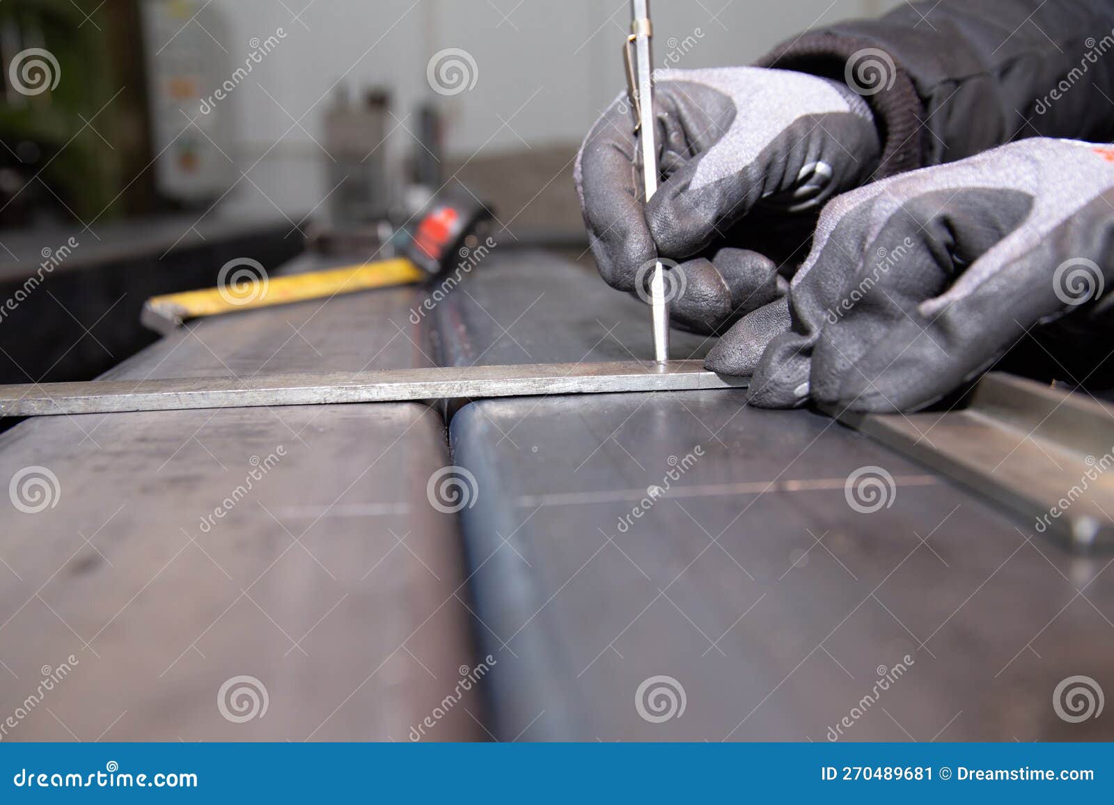 Worker Makes a Mark on Metal Surface. Drilling Holes in Metal Profiles