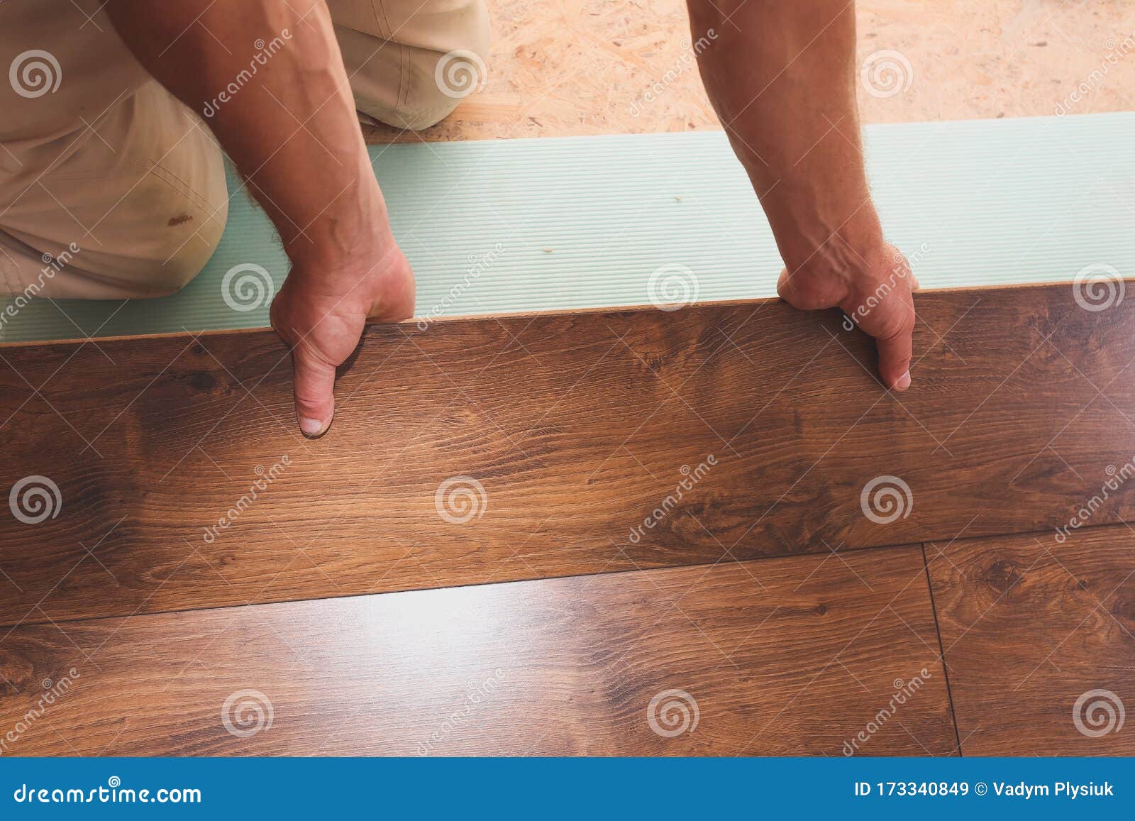 Worker Is Making Laminate Flooring In Apartment Maintenance