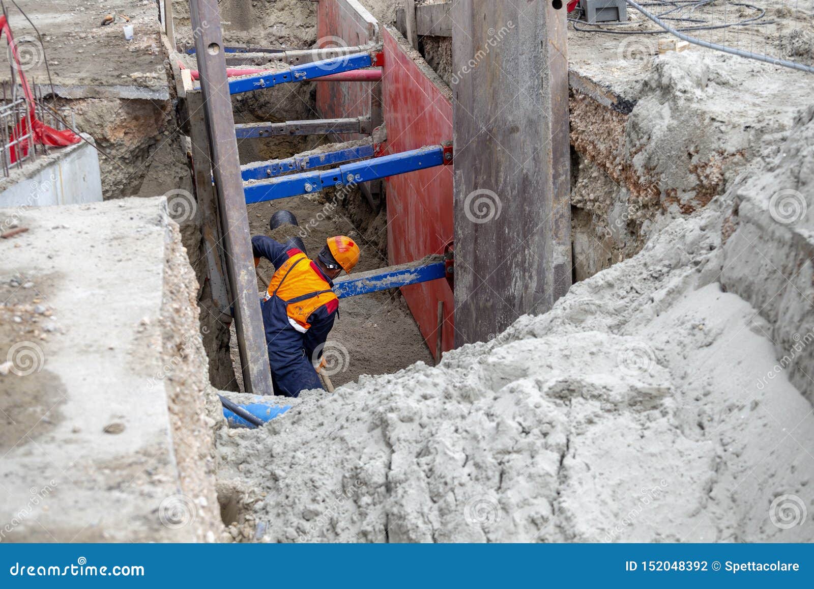worker making trench bed for new pipeline construction