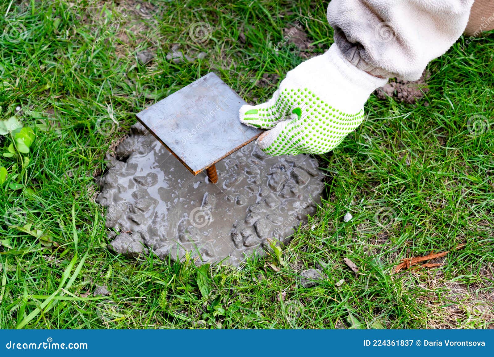 Worker Mans Hands In Gloves Mixing, Stirring Cement Slurry, Concrete
