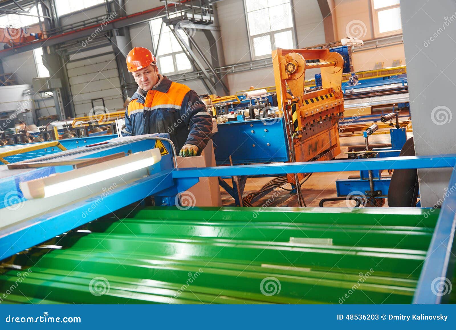 worker at metal sheet profiling factory