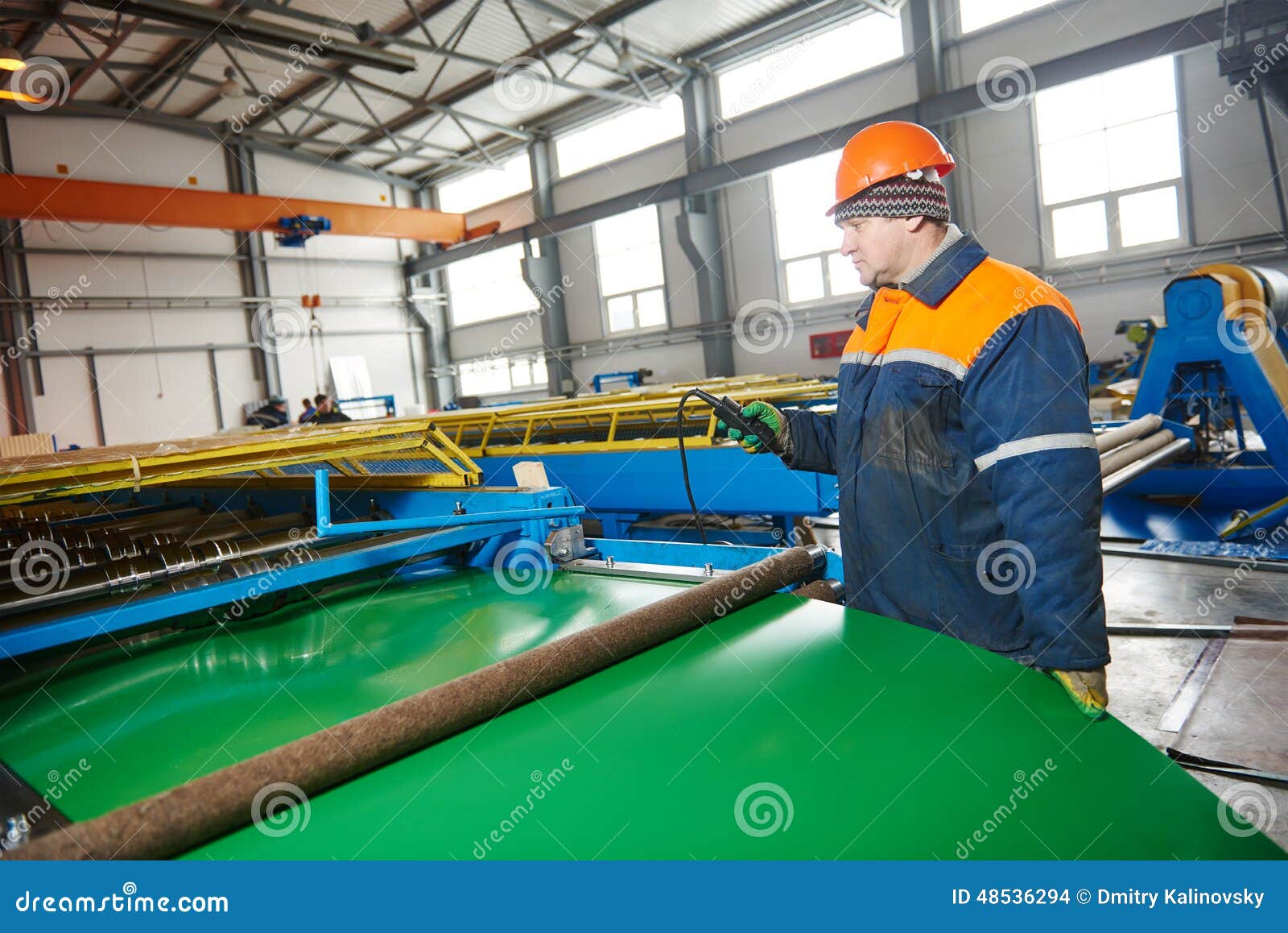 worker at metal sheet profiling factory