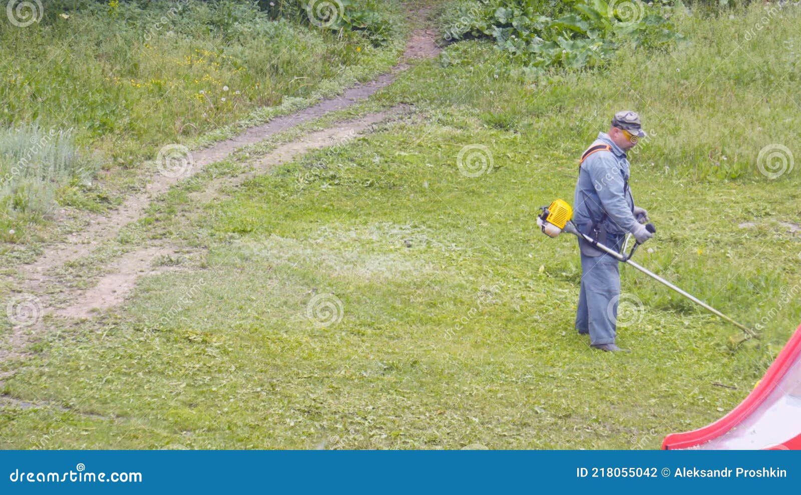 Worker Mows the Grass on the Lawn with a Trimmer Stock Footage Video of mowing, gardening