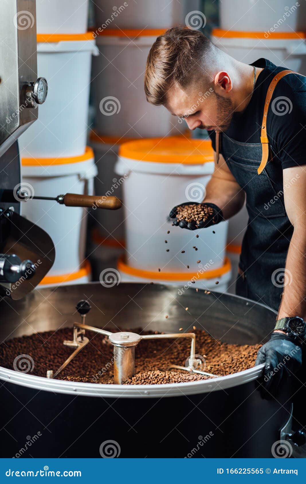A Worker Near Coffee Roasting Equipment Will Check Time for Testing the