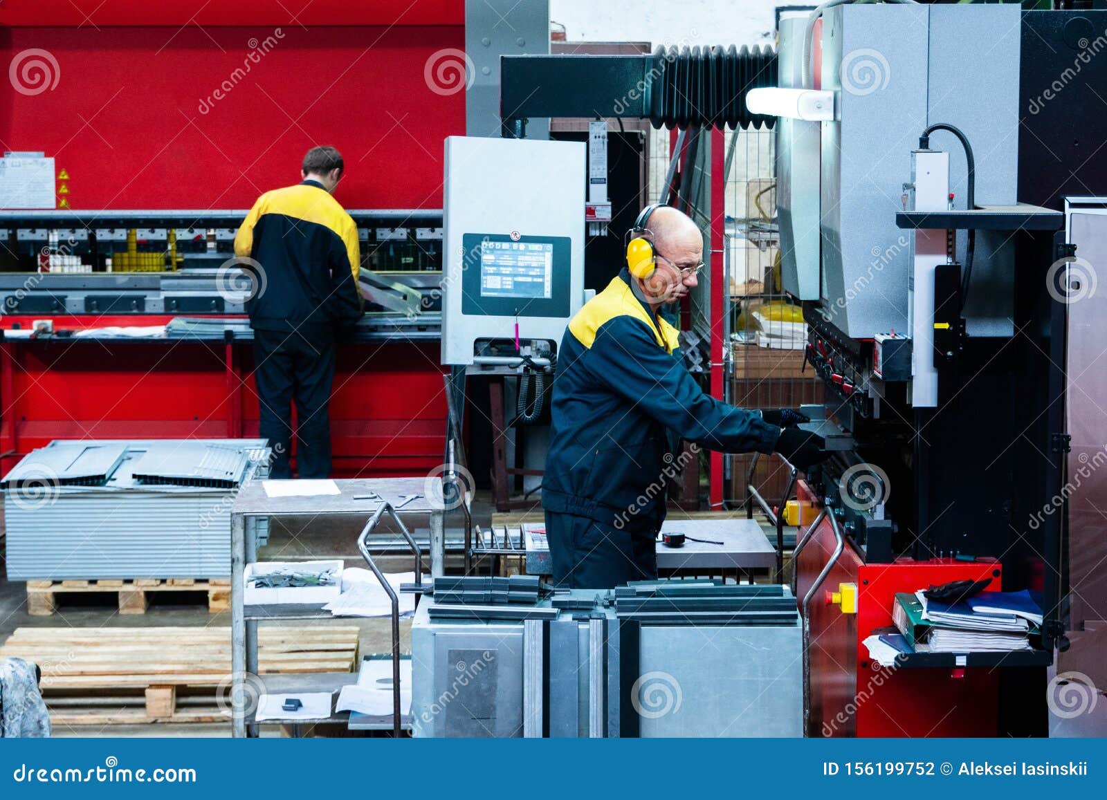 worker operator bending metal sheet process by sheet bending machine for bus manufactuing part, steel folding with