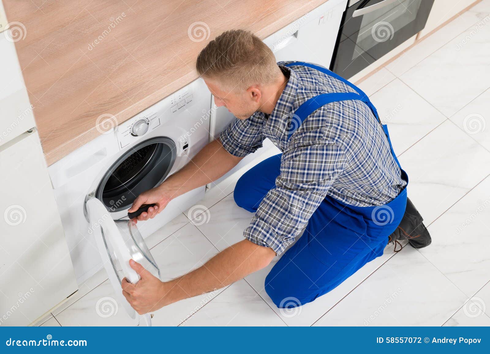 worker in overall fixing washer