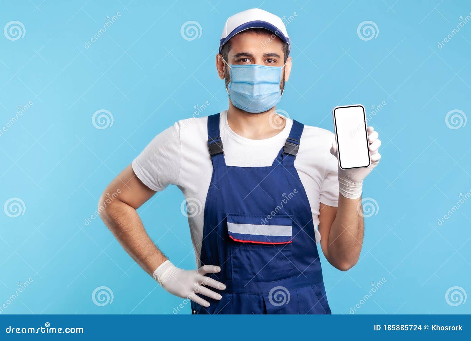 Download Worker In Overalls And Gloves Holding Mobile Phone With Blank Display Device Mock Up For Order App Stock Photo Image Of Arab Display 185885724