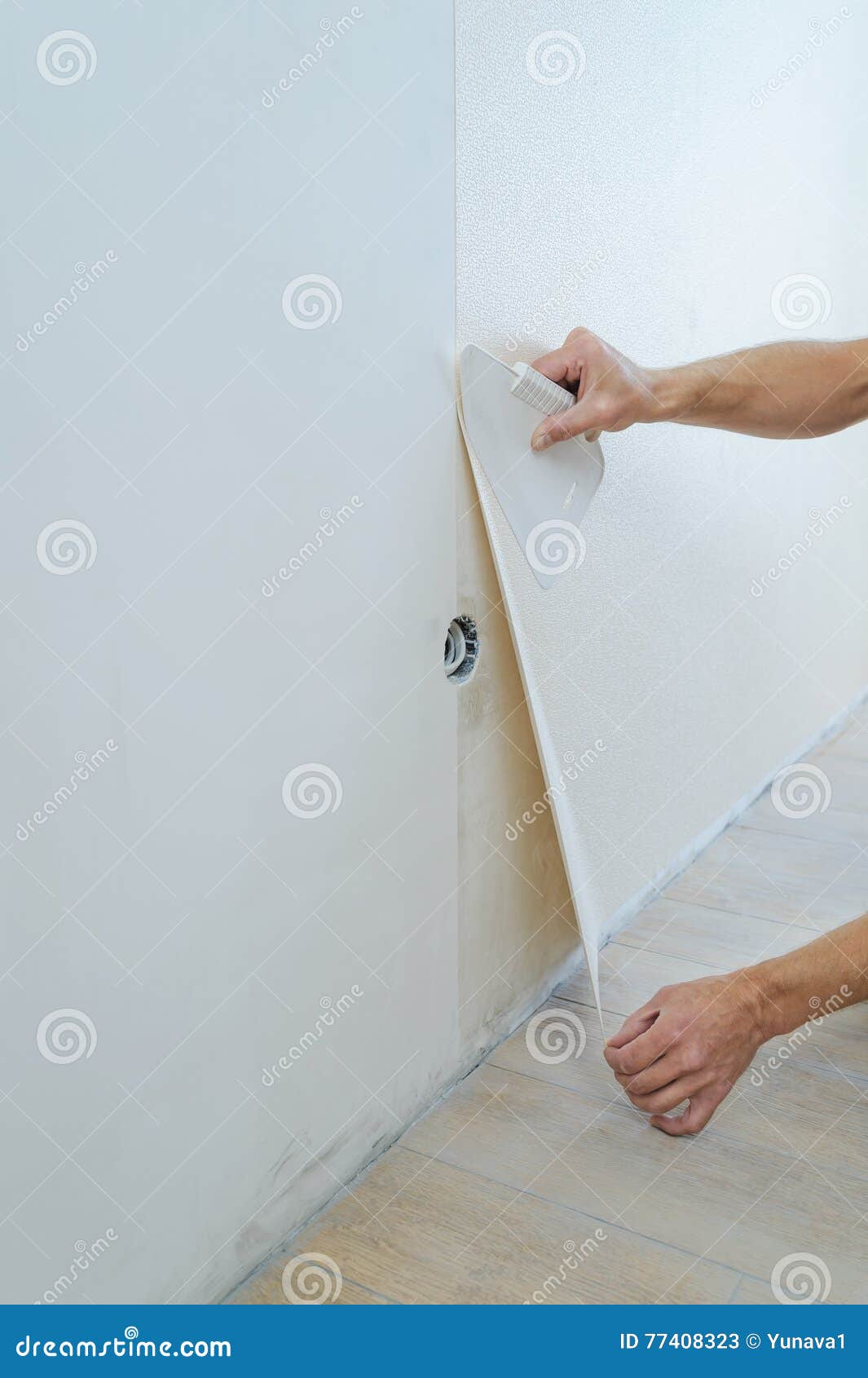 Worker pasting wallpapers. stock image. Image of remodel 77408323