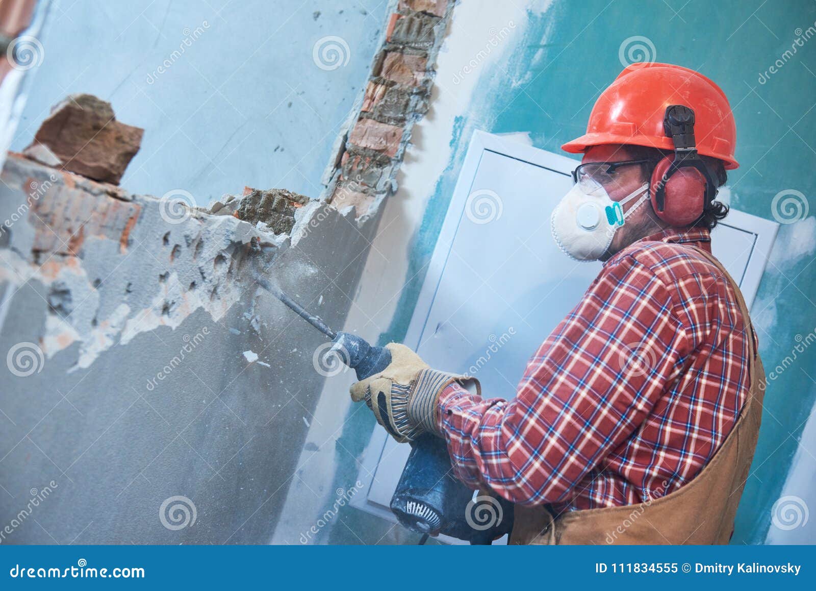 Worker with Demolition Hammer Breaking Interior Wall Stock Image