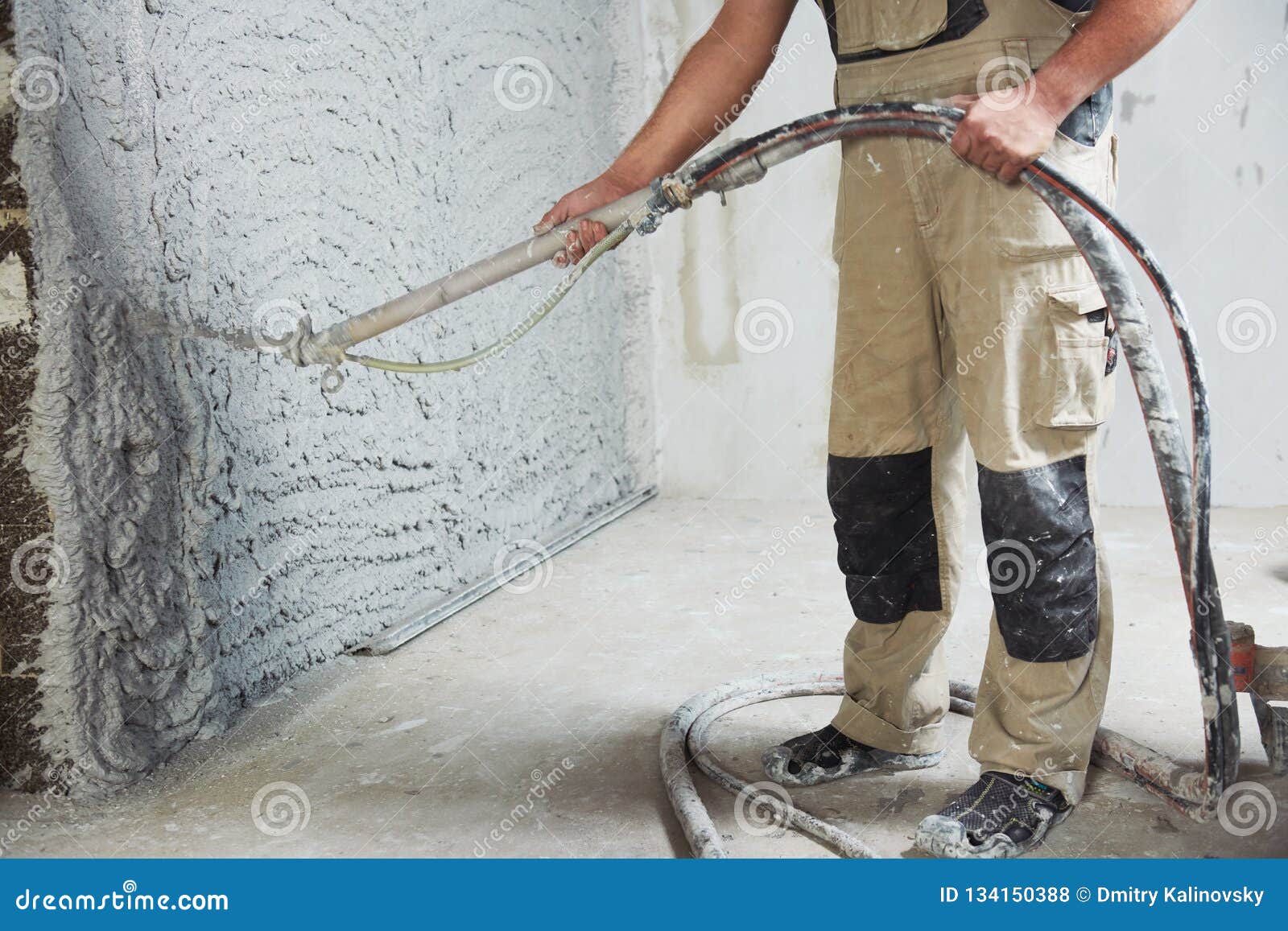 plastering the interior wall with an automatic spraying plaster pump machine