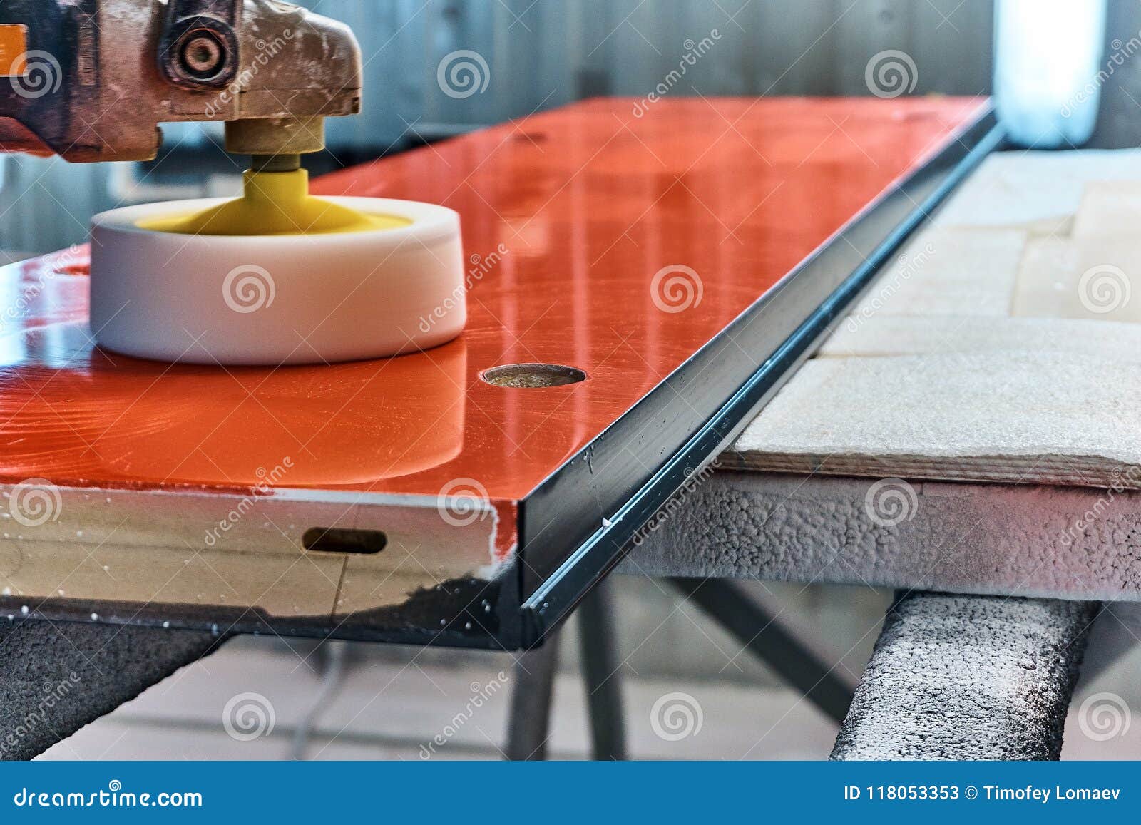 Worker Polishes A Red Panel With A Grinder. Woodworking 