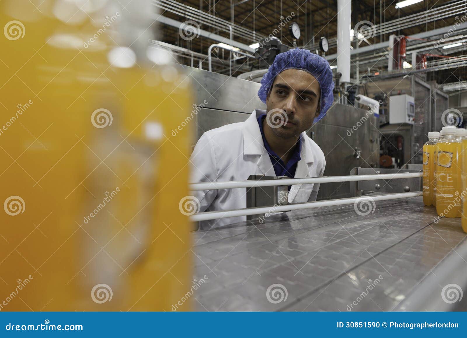 Worker on Production Line Looking Down Conveyor Belt Editorial Image