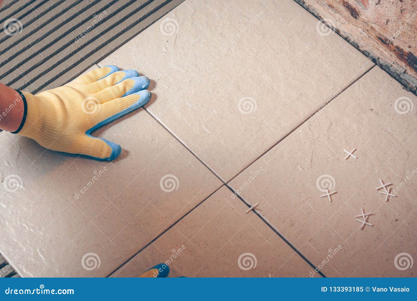 the worker professionally puts the tile