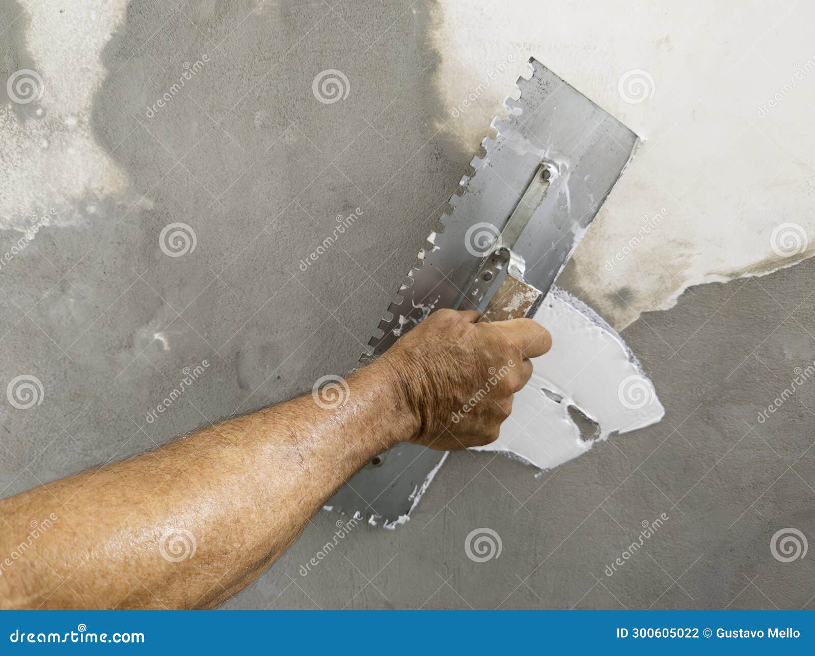 Worker Puts Finishing Layer of Stucco on the Wall Using a Plastering