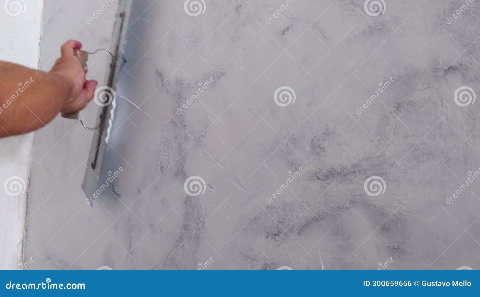 Worker Puts Finishing Layer of Stucco on the Wall Using a Plastering