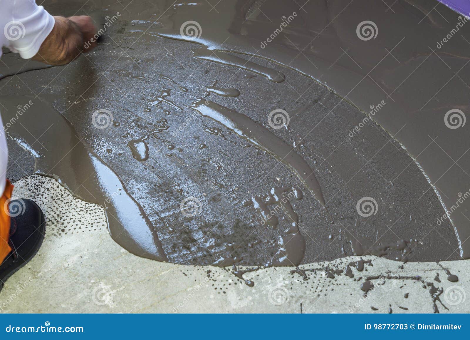 Worker Puts A Self Leveling Screed With Tool On Concrete Floor I