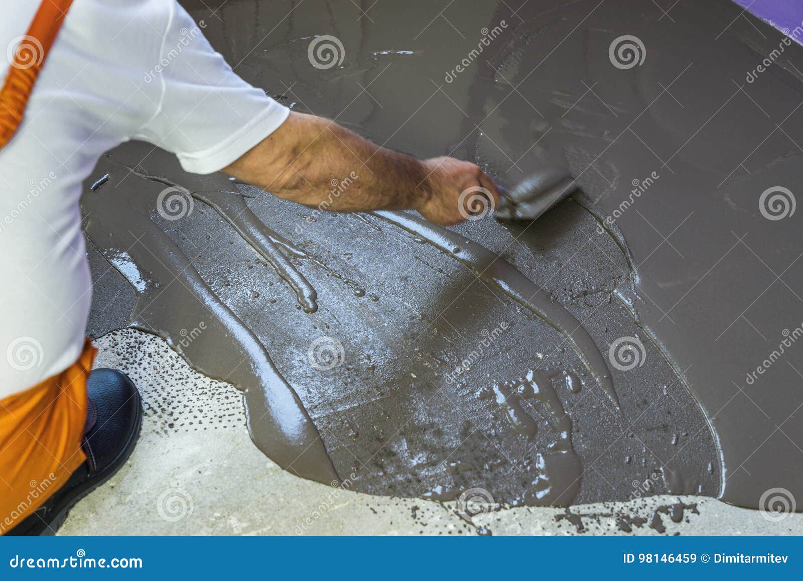 Worker Puts A Self Leveling Screed With Trowel On Cement Floor I