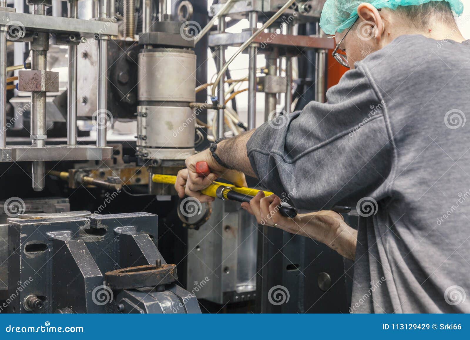 Worker Repairs a Machine for Plastic Injection Stock Image Image of