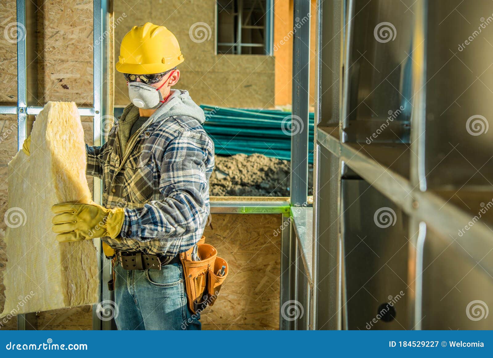 worker in safe breathing mask working inside developed building