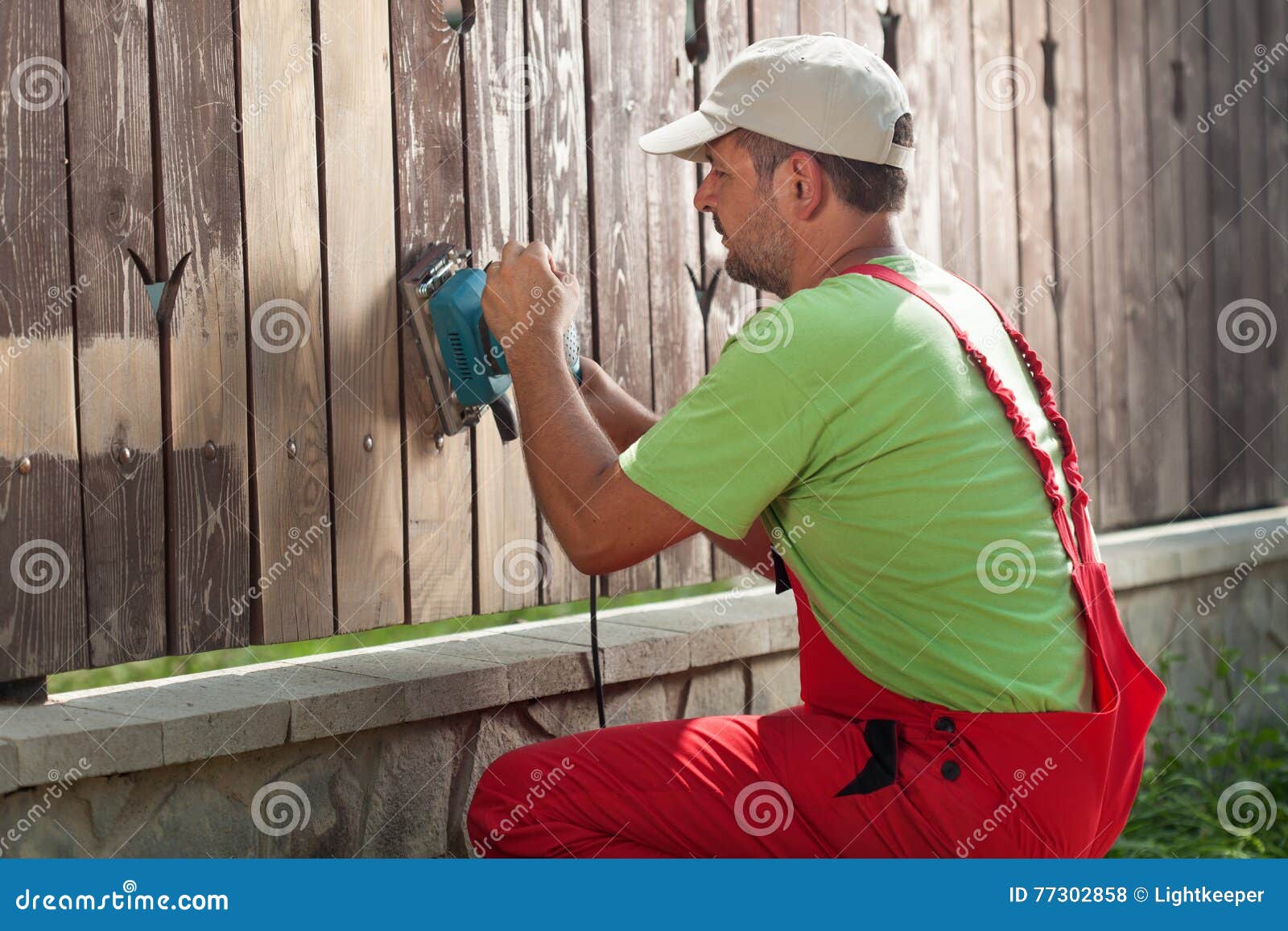 Worker Sanding Away Old Paint from a Wooden Fence Stock Photo Image of impregnate, hand 77302858