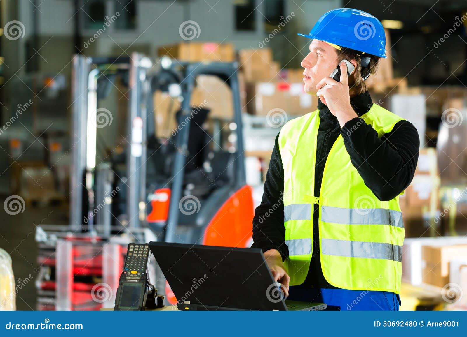 worker with scanner and laptop at forwarding