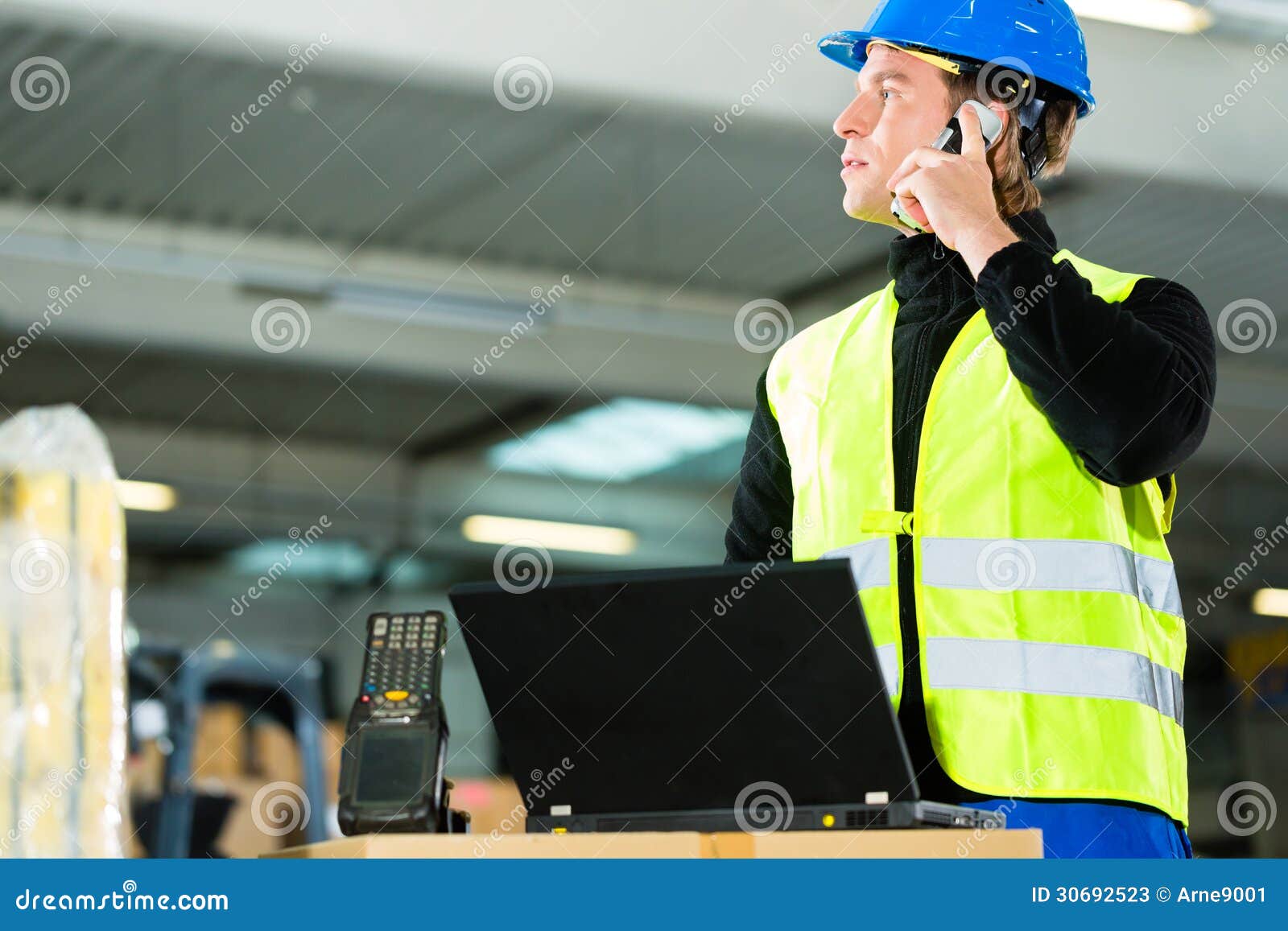 worker with scanner and laptop at forwarding