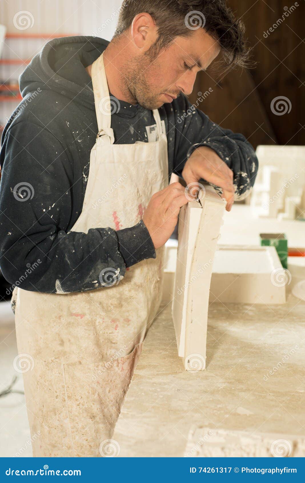 worker separating plaster model from mold