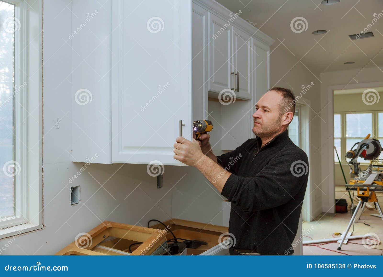 Worker Sets a New Handle on the White with a Screwdriver