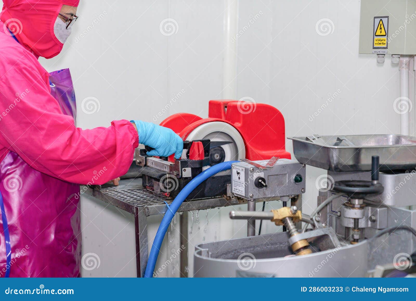Worker Sharpening Knife with Electric Grinding Stone Stock Image