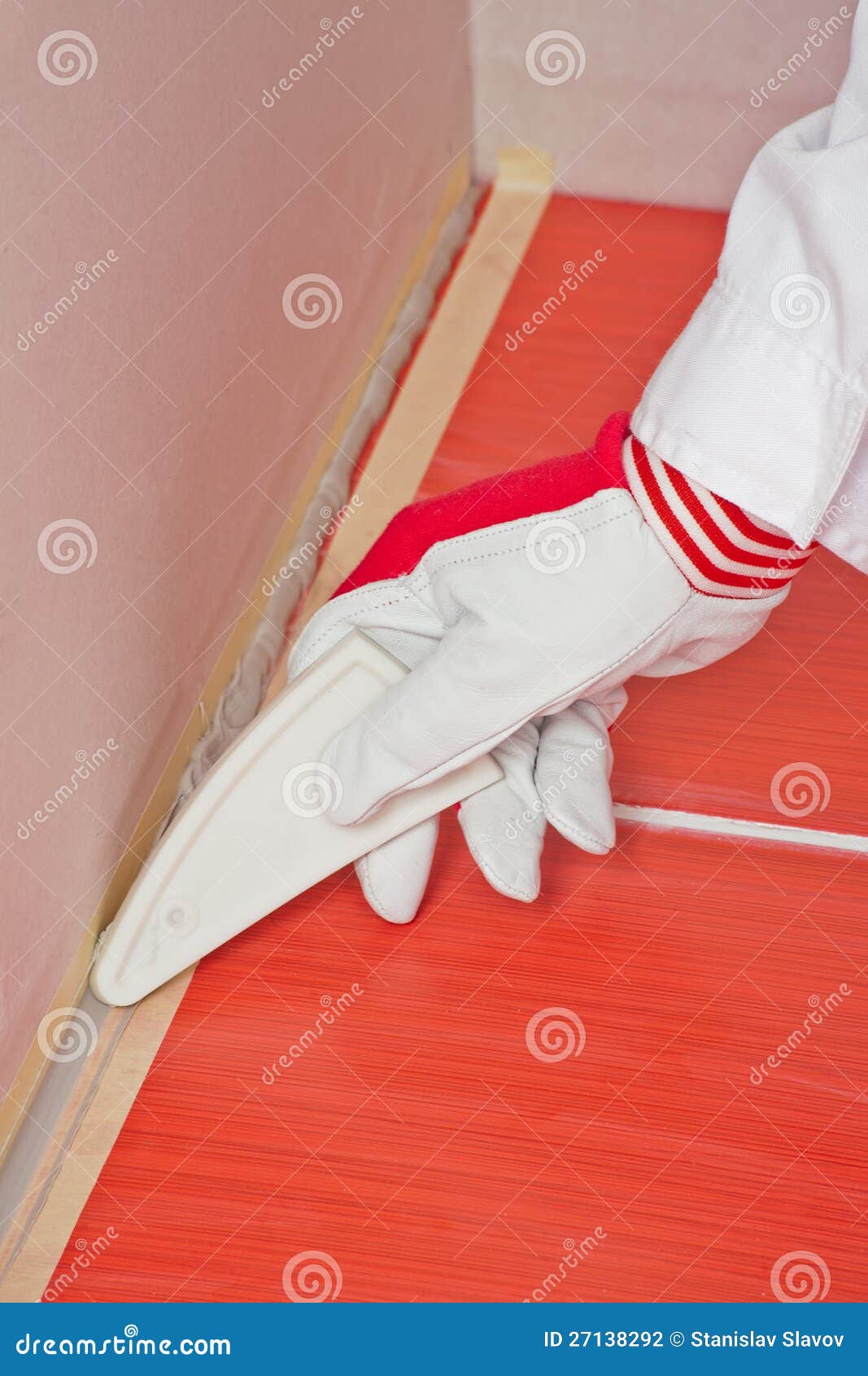 worker smooths silicone sealant