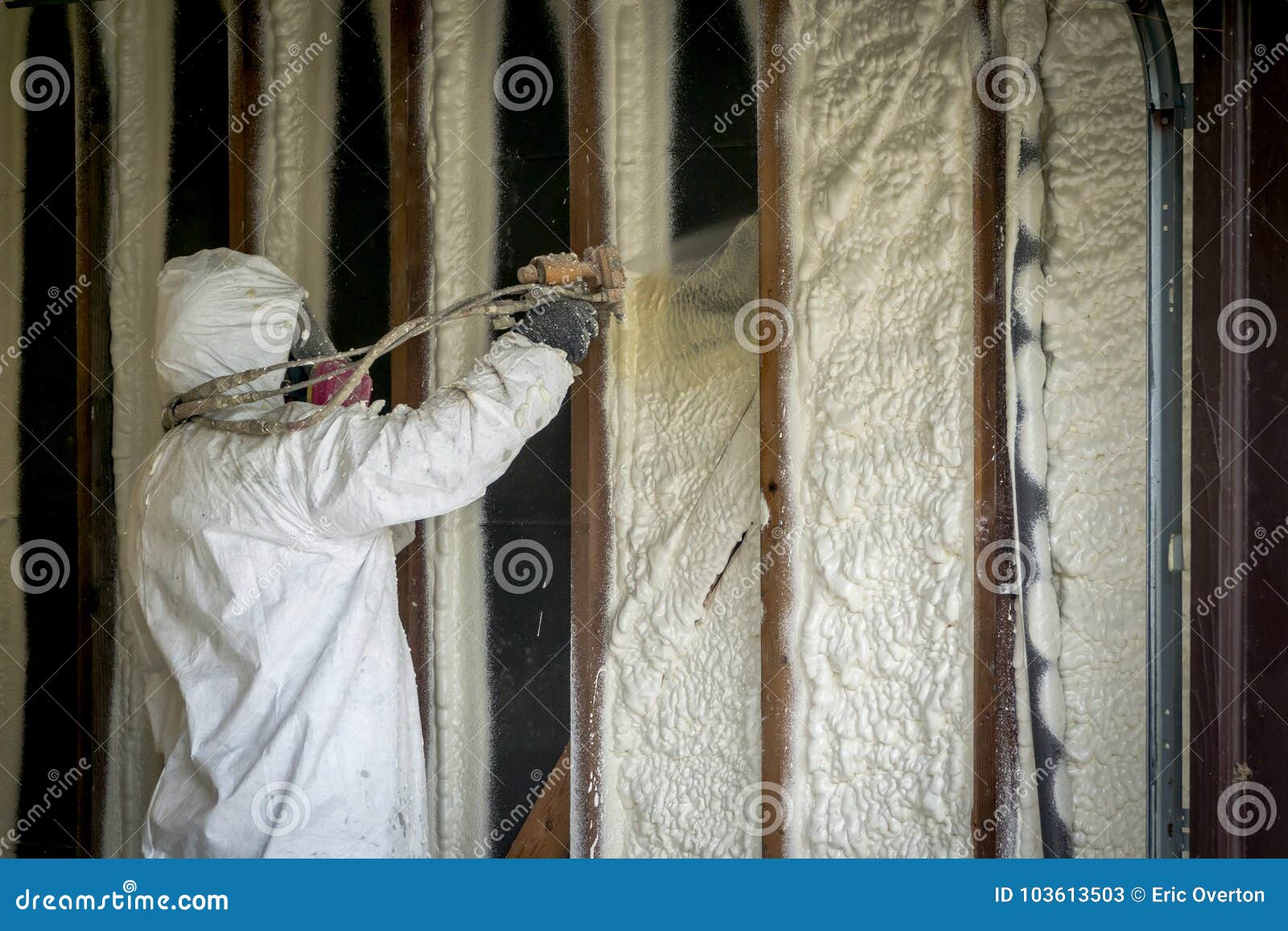 worker spraying closed cell spray foam insulation on a home wall