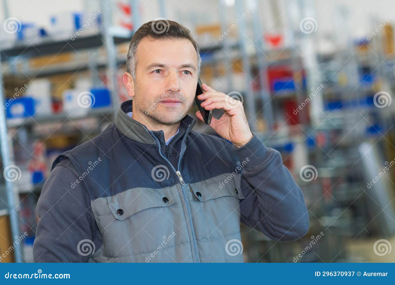 Worker Talking on Cell Phone in Warehouse Stock Image Image of