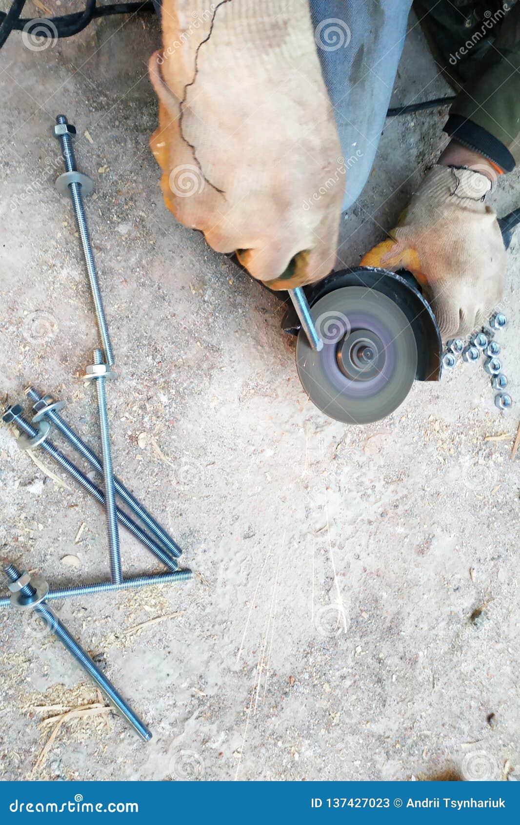 The Worker Uses an Angle Grinder To Sharpen the Bolts, a Closeup Plan