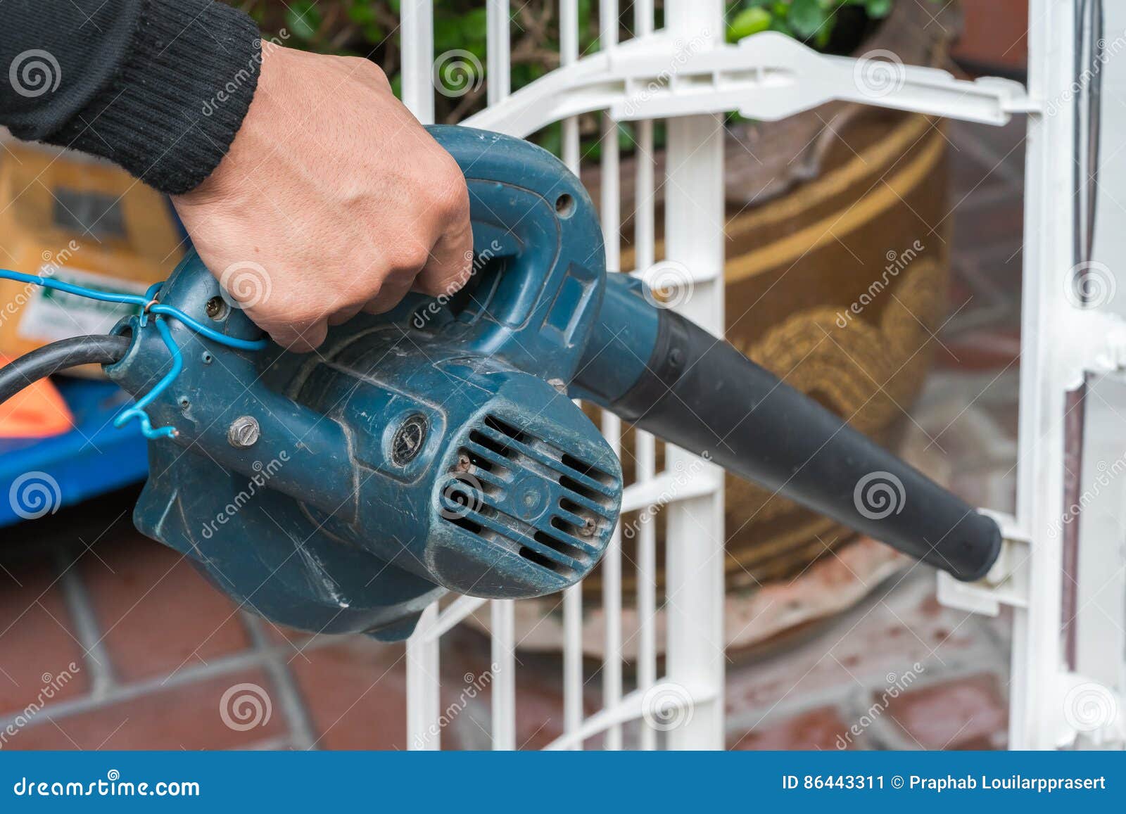 Worker Uses a Handheld Blower To Remove Dust Stock Image Image of