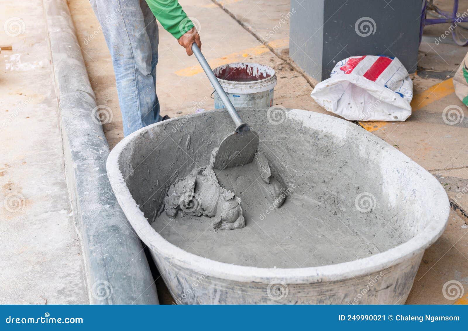 A Worker Uses a Hoe To Mix Mortar in a Brucket Stock Image Image of