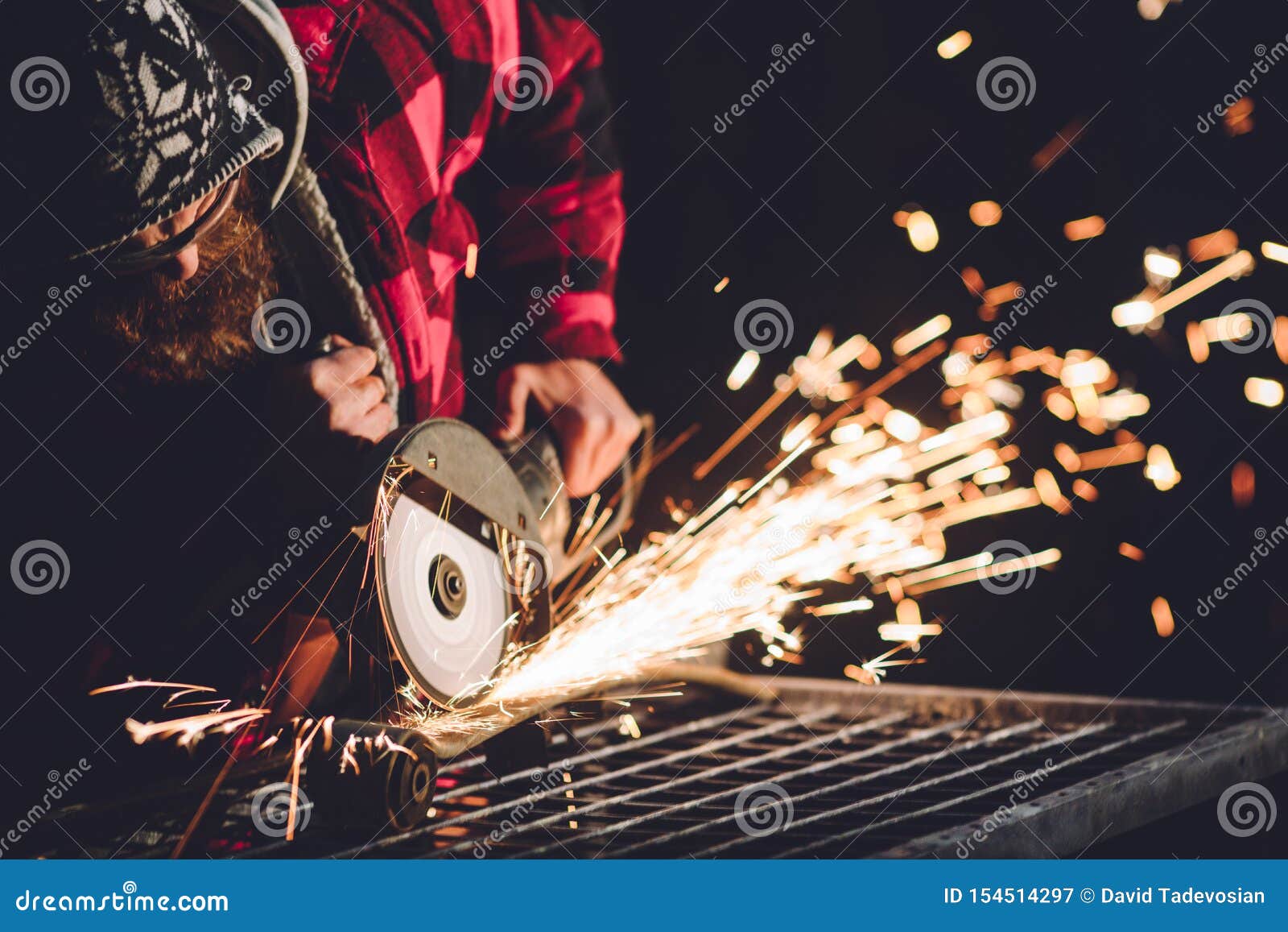 Worker Using Angle Grinder in Factory and Throwing Sparks. Stock Image