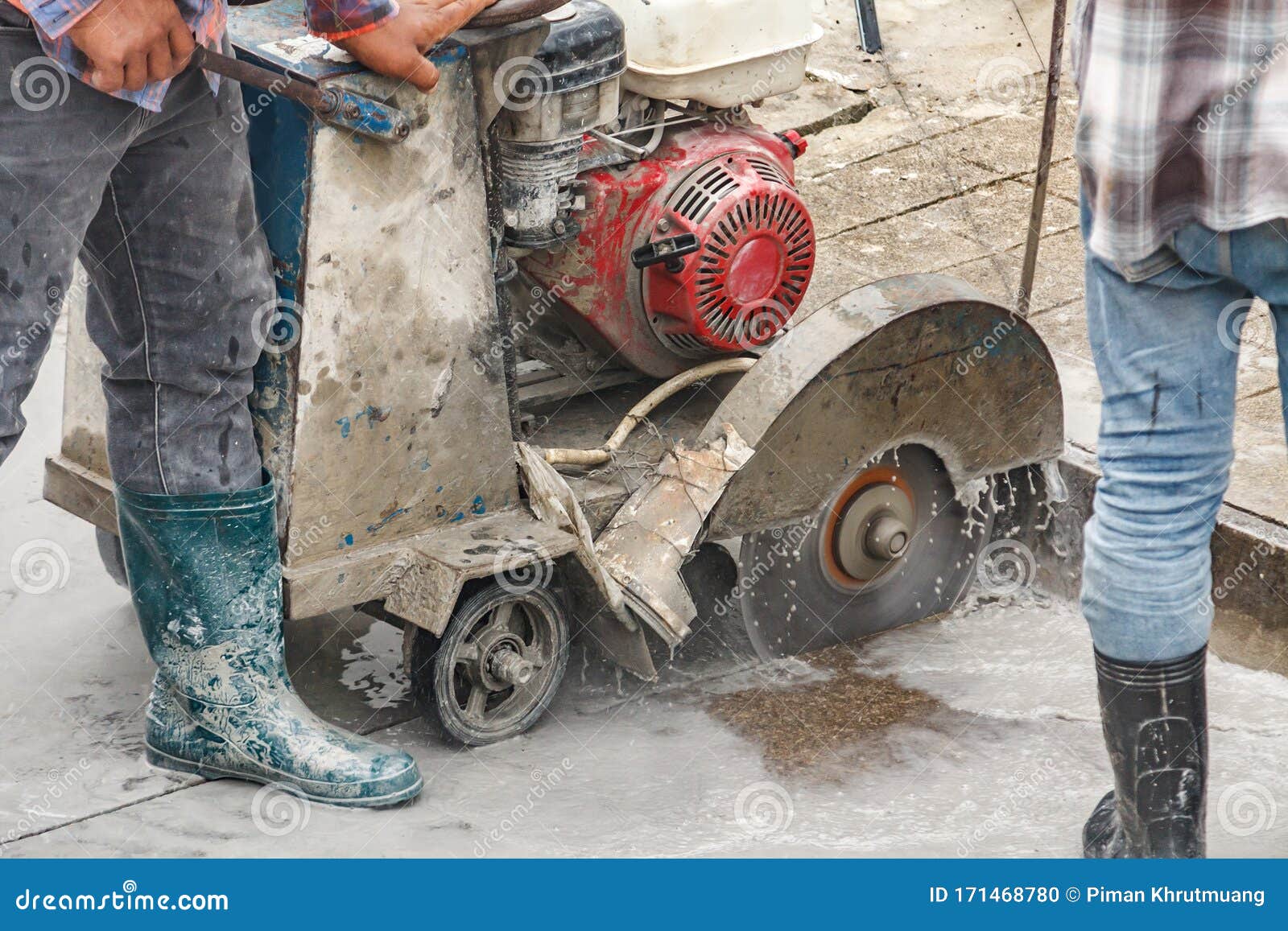 Worker Using Diamond Saw Blade Machine Cutting Concrete Road at Construction Site Stock Photo