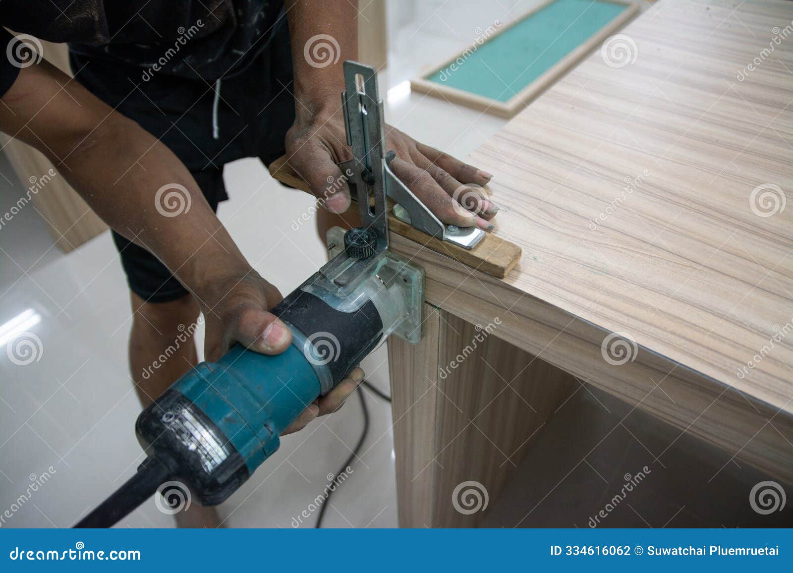 worker using a gouge on an old wooden cabinet