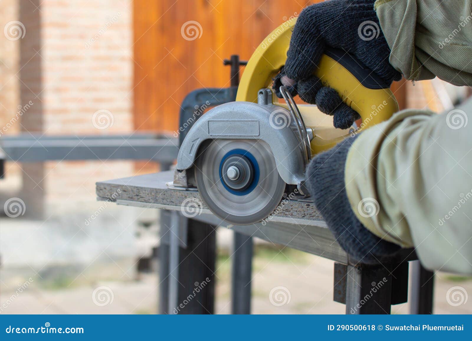 Worker Using a Grinding Machine for Cut Cement Board Stock Photo