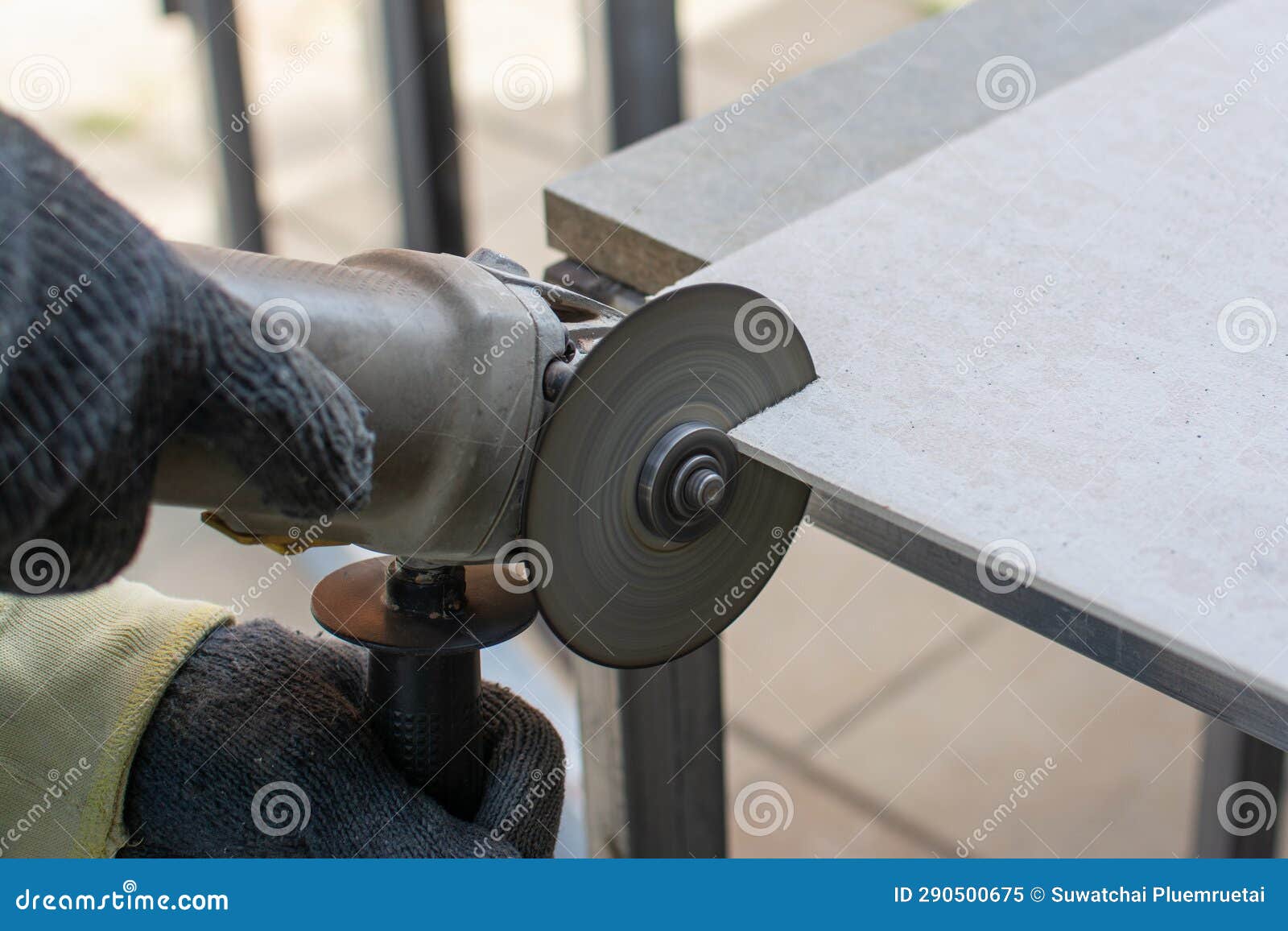 Worker Using a Grinding Machine for Cut Cement Board Stock Image