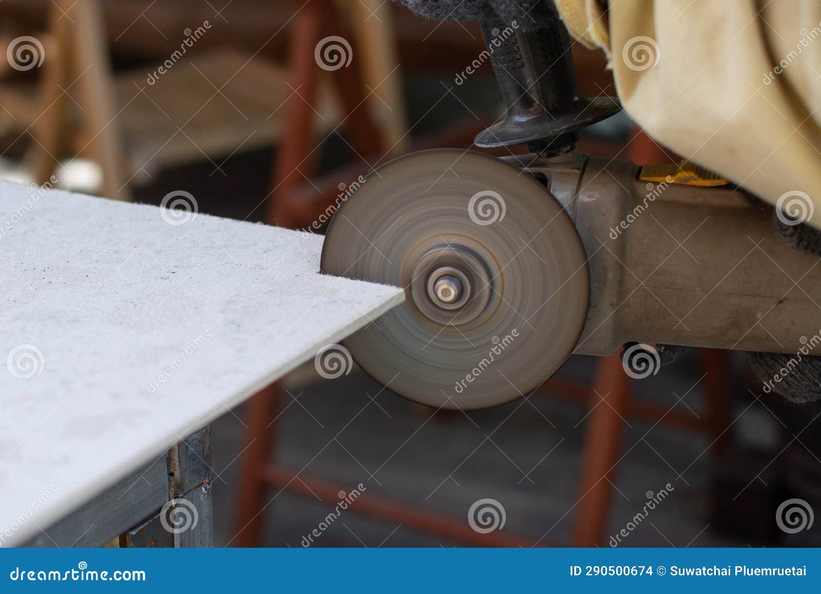 Worker Using a Grinding Machine for Cut Cement Board Stock Photo