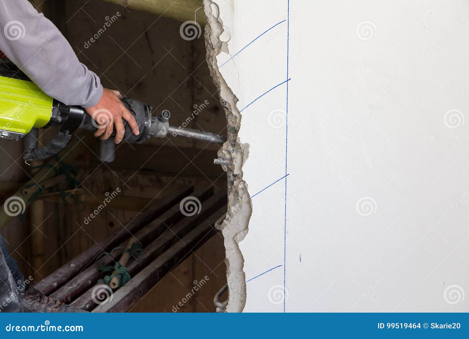Worker Using a Jackhammer To Drill into Wall. Stock Photo Image of