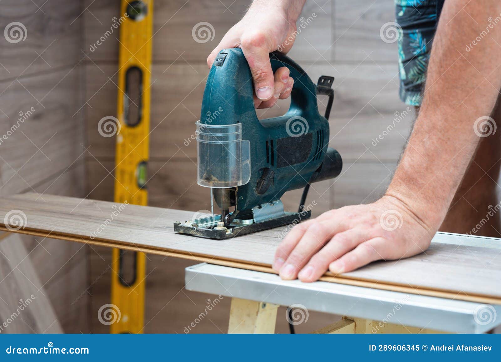 A Worker Using a Jigsaw Saws Laminate Boards Stock Image Image of