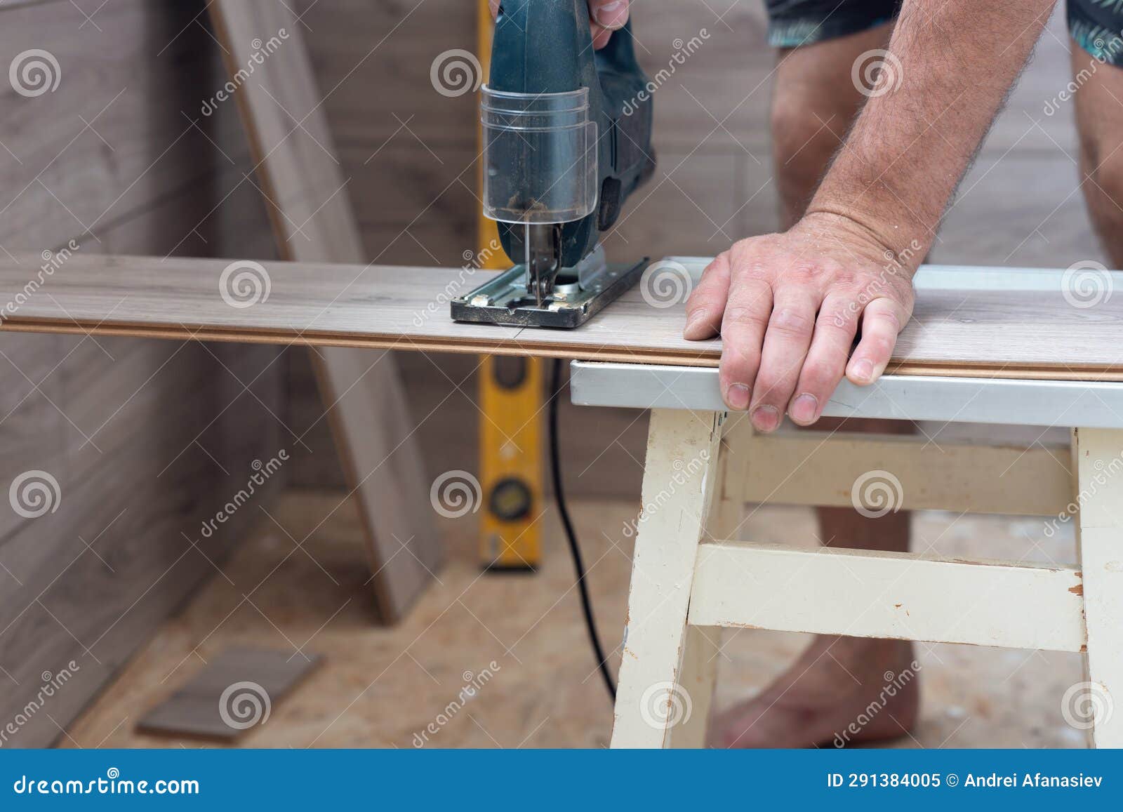 A Worker Using a Jigsaw Saws Laminate Boards Stock Image Image of
