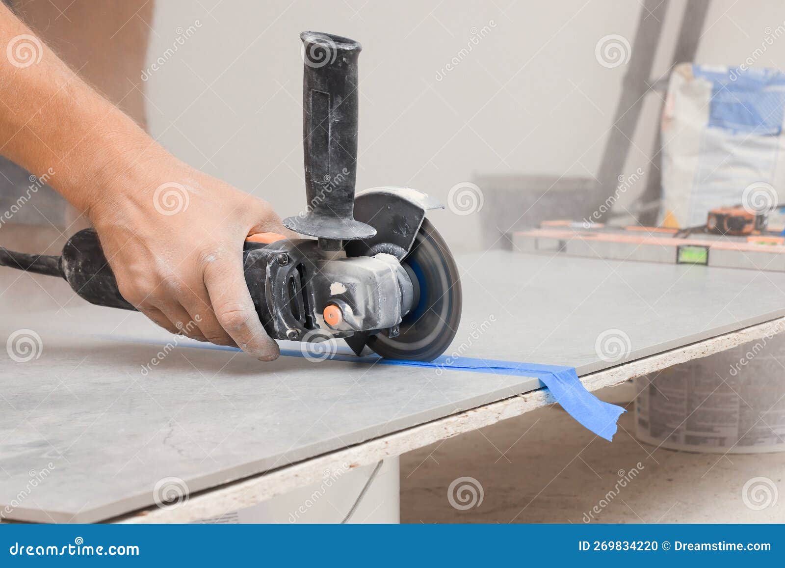 Worker Using Saw with Circular Diamond Blade for Tile Cutting Indoors, Closeup Stock Photo