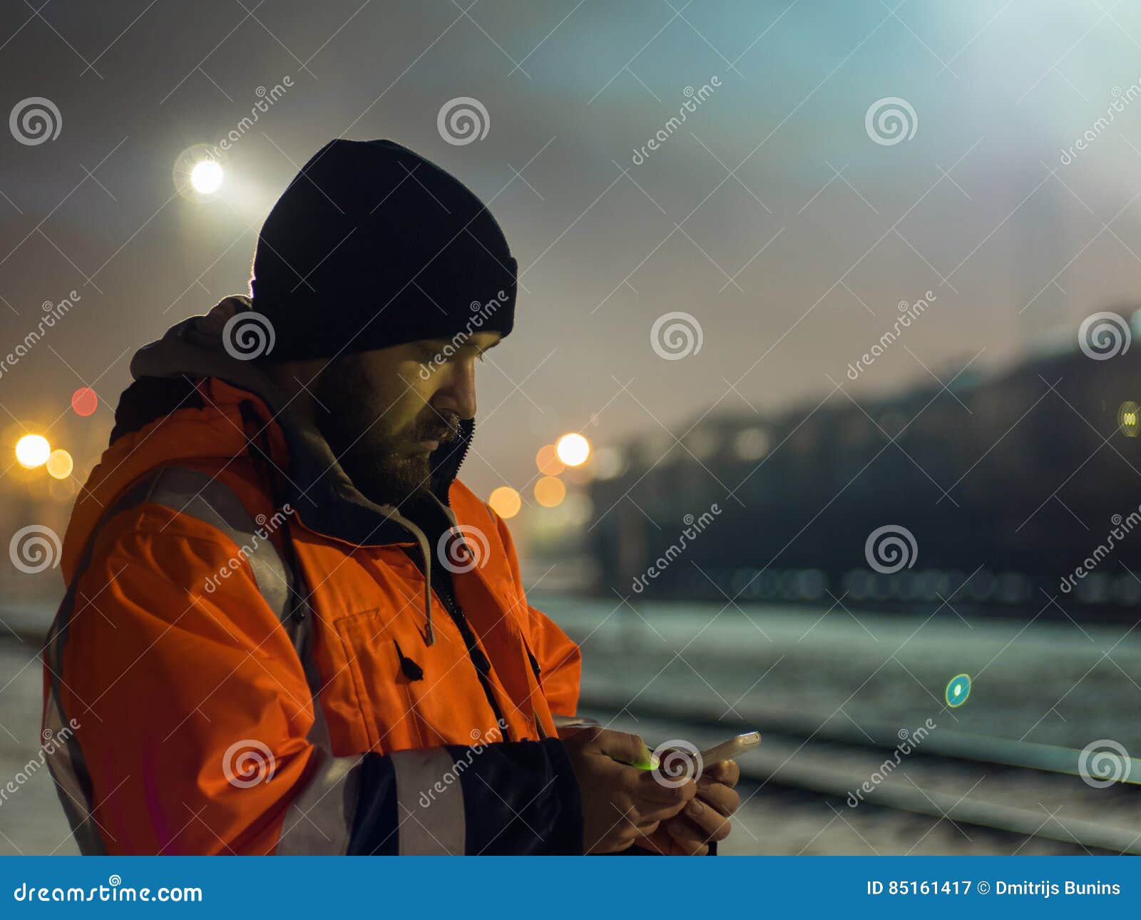 worker using smartphone in the twilight. concept of night shift