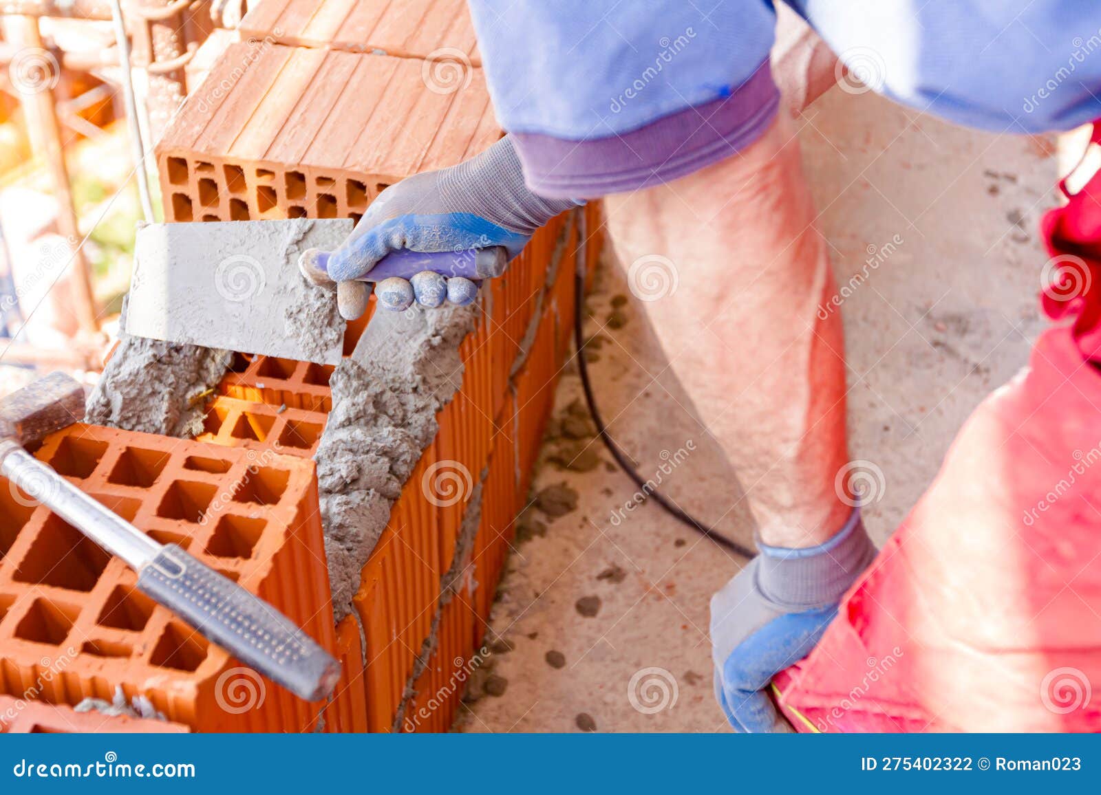 Worker is Using Spatula, Trowel, To Scrape Off Any Excess Mortar that