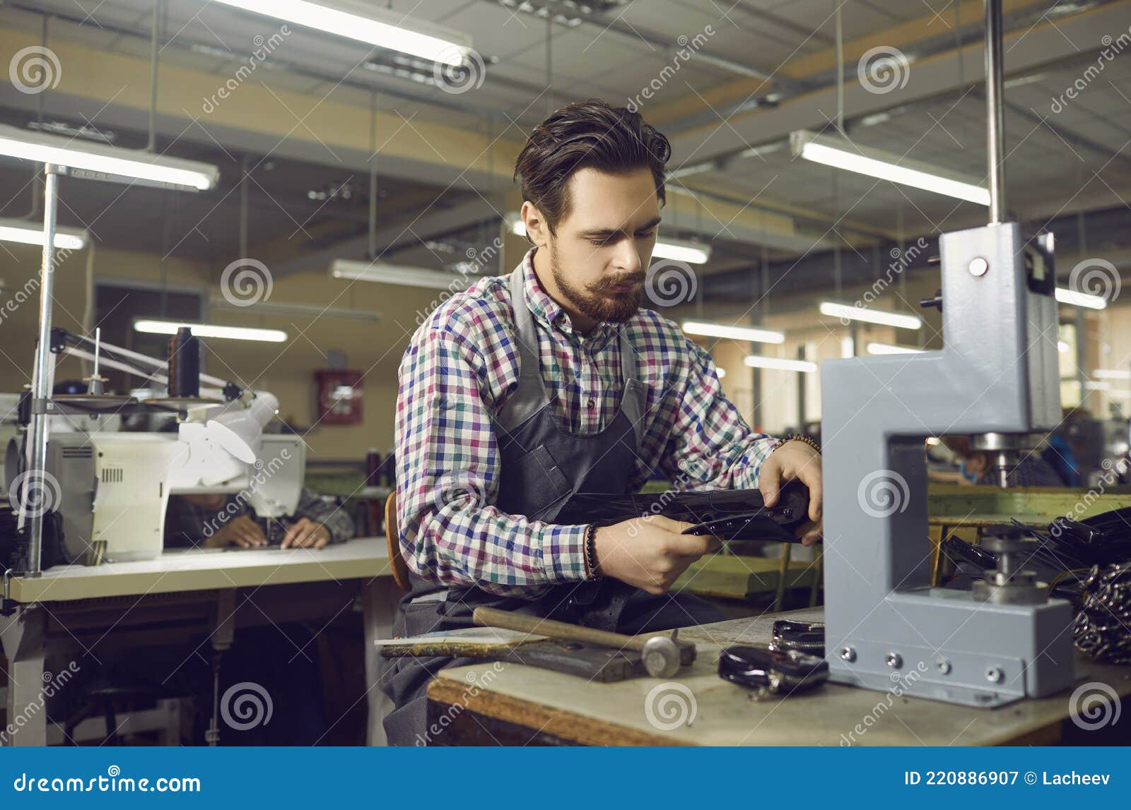 Worker Using Special Tools and Making New Leather Boots at of