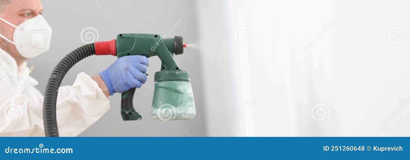 Worker Using Spray Gun for Coloring Wall in White. Effective and Fast